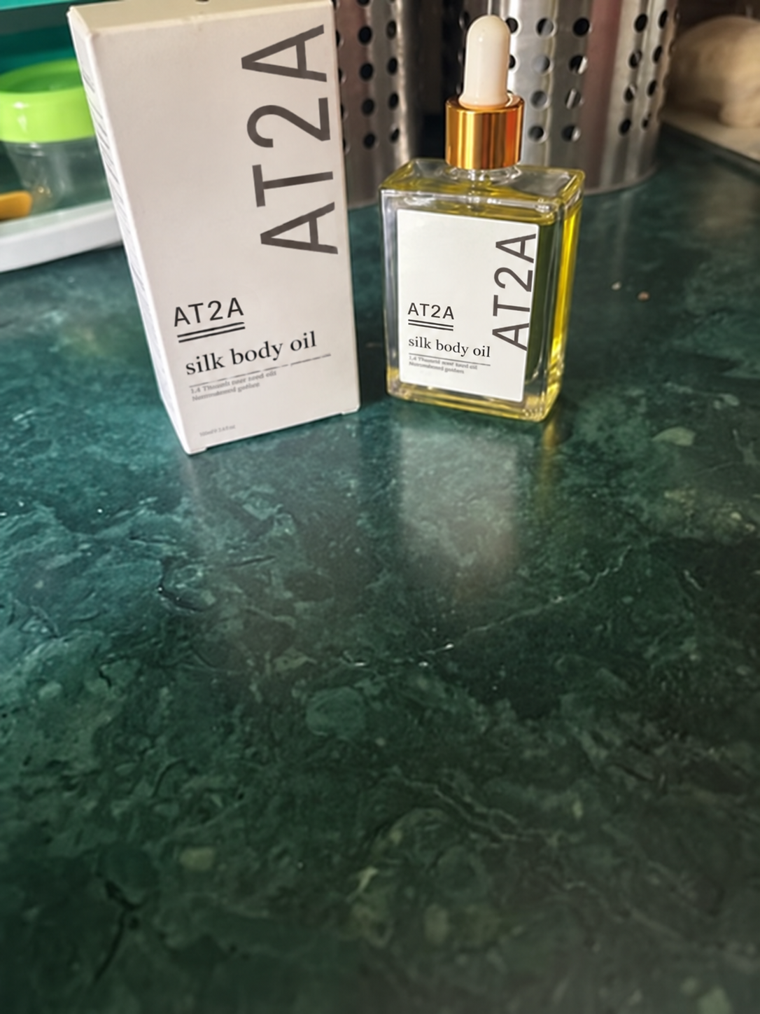 AT2A Silk Body Oil on a beauty counter